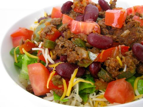 Bison taco bowl with fresh veggies and ripe tomatoes