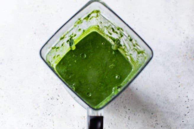 using a blender to blend spinach soup