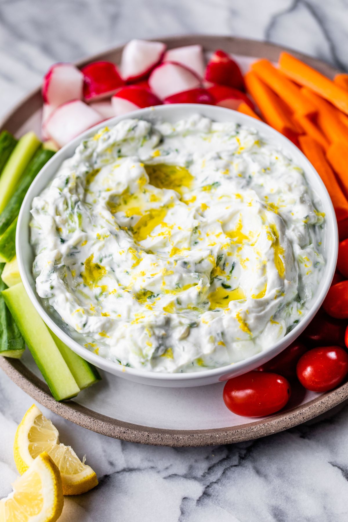 Tzatziki served with celery, tomatoes and carrots.