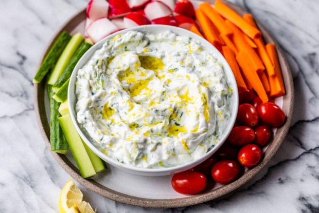 Tzatziki sauce served in a small bowl with veggies.