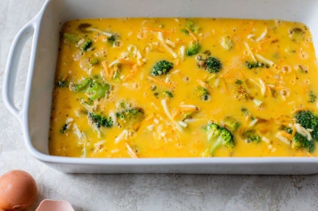 layering broccoli, cheese and eggs in a casserole dish