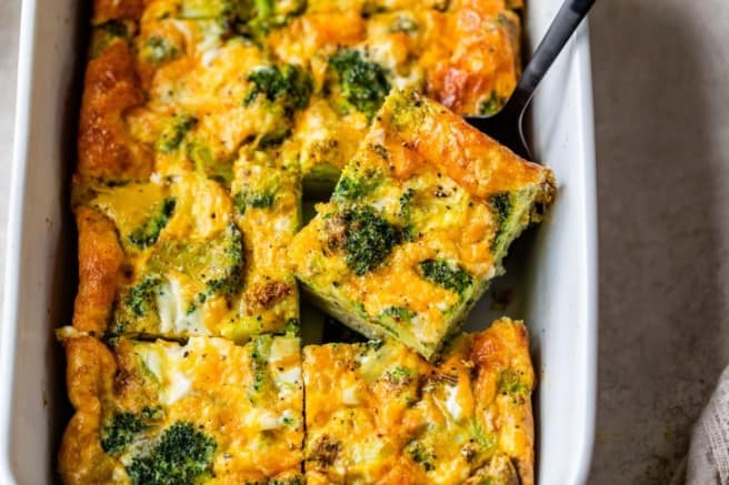 broccoli and cheese egg bake in a white casserole dish