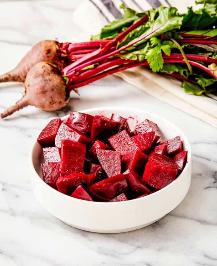 cubed steamed beets in a small white bowl