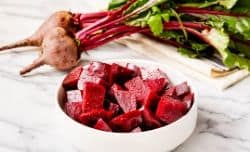 steamed beets cubed and in a white bowl