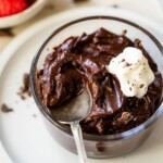 Chocolate avocado pudding with a spoonful on top.