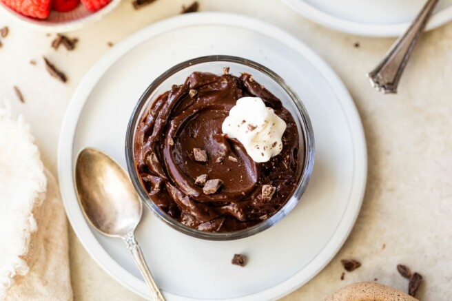 Chocolate pudding served in a small glass bowl.