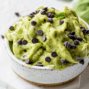 Mint chip ice cream in a white bowl.