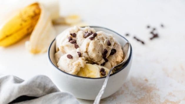 Frozen banana ice cream in a bowl topped with mini chocolate chips.