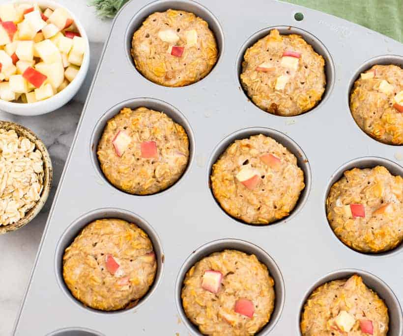 apple protein muffins baked and in a muffin pan