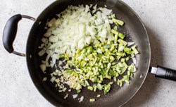 onions, garlic and collard stems in pan