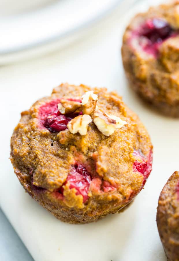 Pumpkin Cranberry Muffins topped with chopped pecans