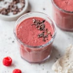 chocolate raspberry smoothie topped with cacao nibs