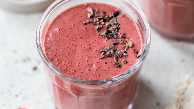 chocolate raspberry smoothie topped with cacao nibs