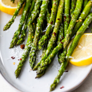 freshly roasted asparagus on a white platter
