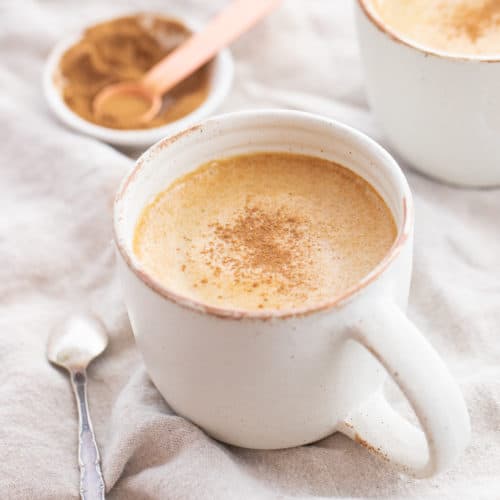 pumpkin spice latte in a white mug, topped with nutmeg