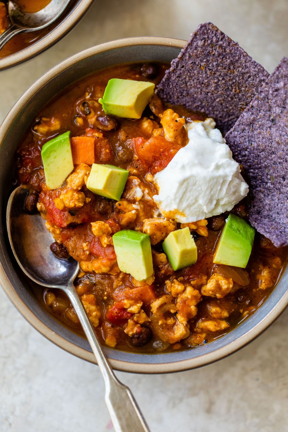 Pumpkin chili topped with diced avocado and sour cream.