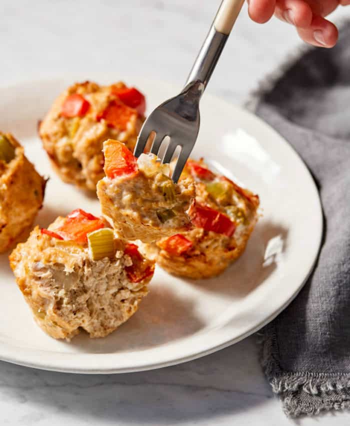 using a fork to take a bite of a meatloaf muffin