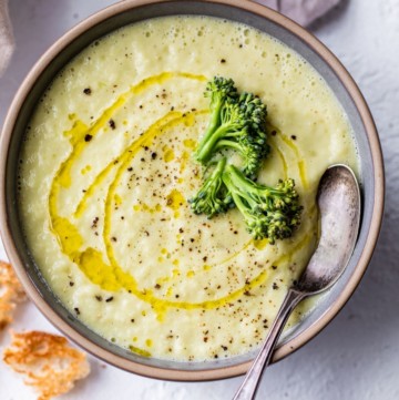 Broccoli stem soup in a bowl with a spoon.