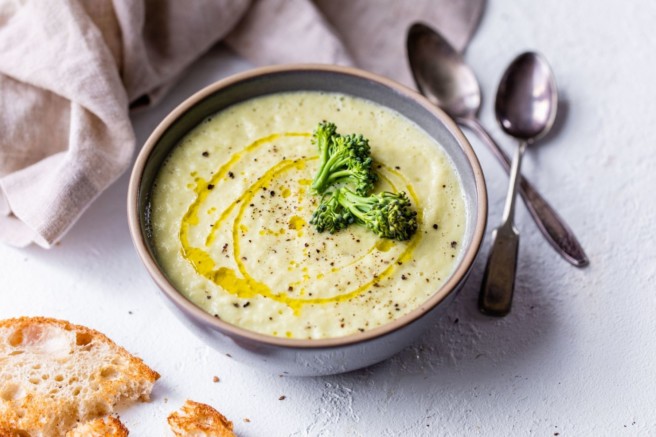 Broccoli Soup in a bowl served with bread.