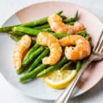shrimp and green beans on small plate with fork