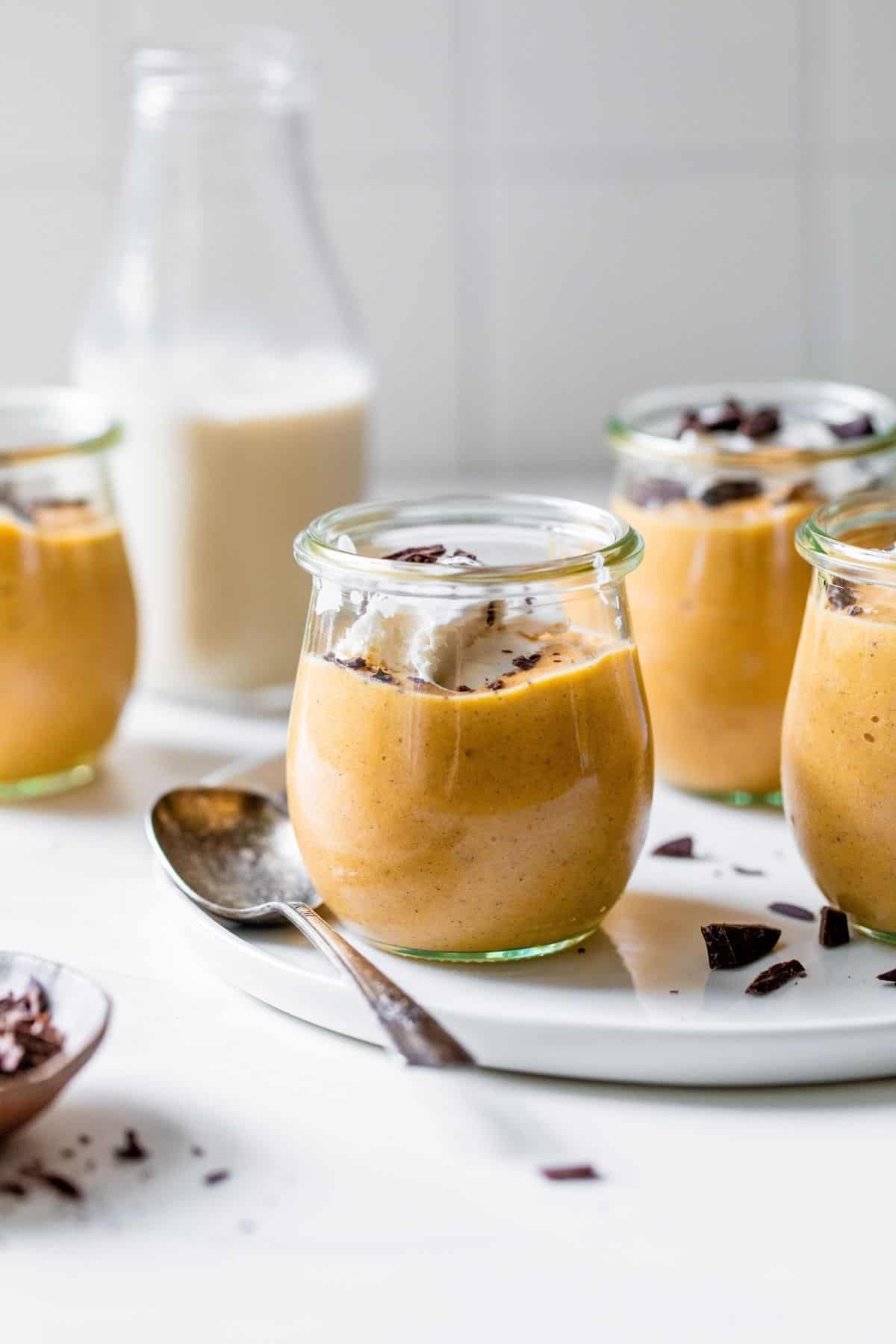 pumpkin mousse in a small jar served with a jug of milk