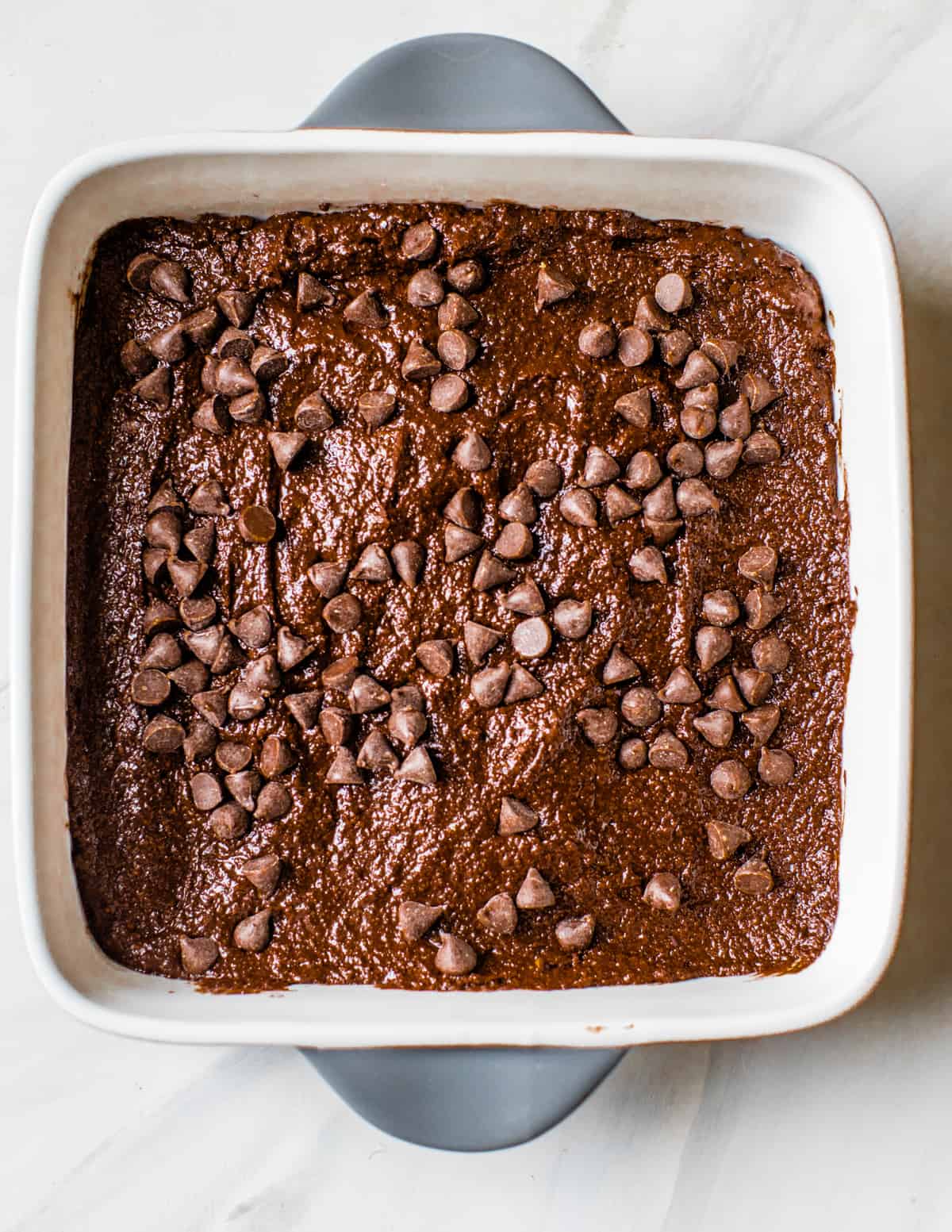 fudgy, chocolate chunk avocado brownies in a square dish