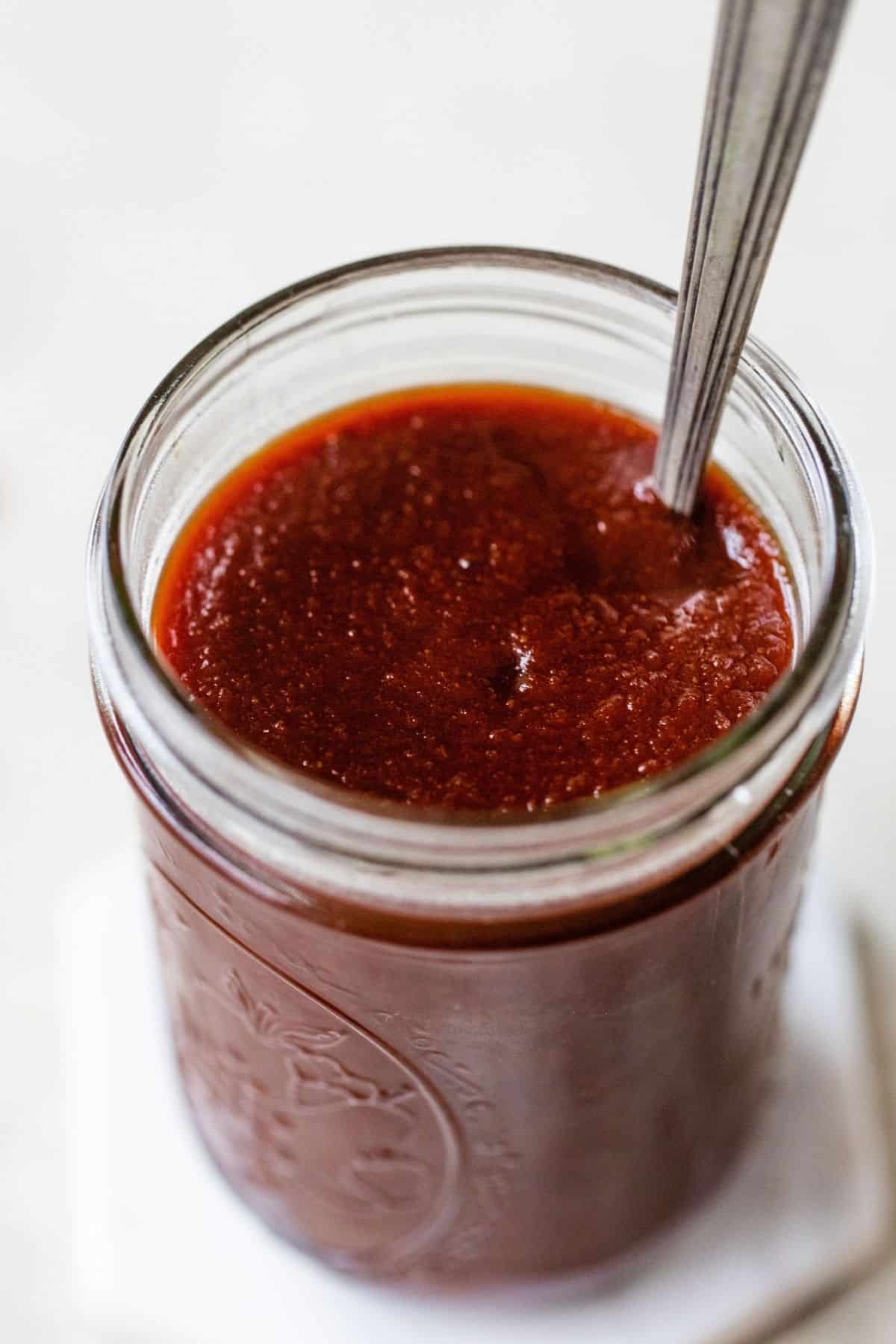 Barbecue sauce in a small glass jar.