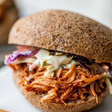 Shredded BBQ chicken and coleslaw on a bun.