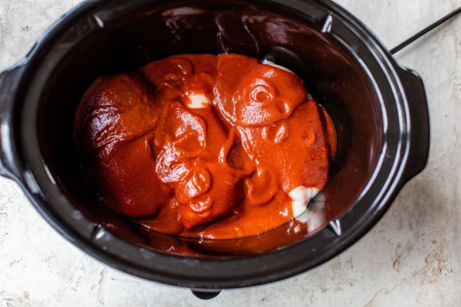 Cooking chicken with BBQ sauce in slow cooker.