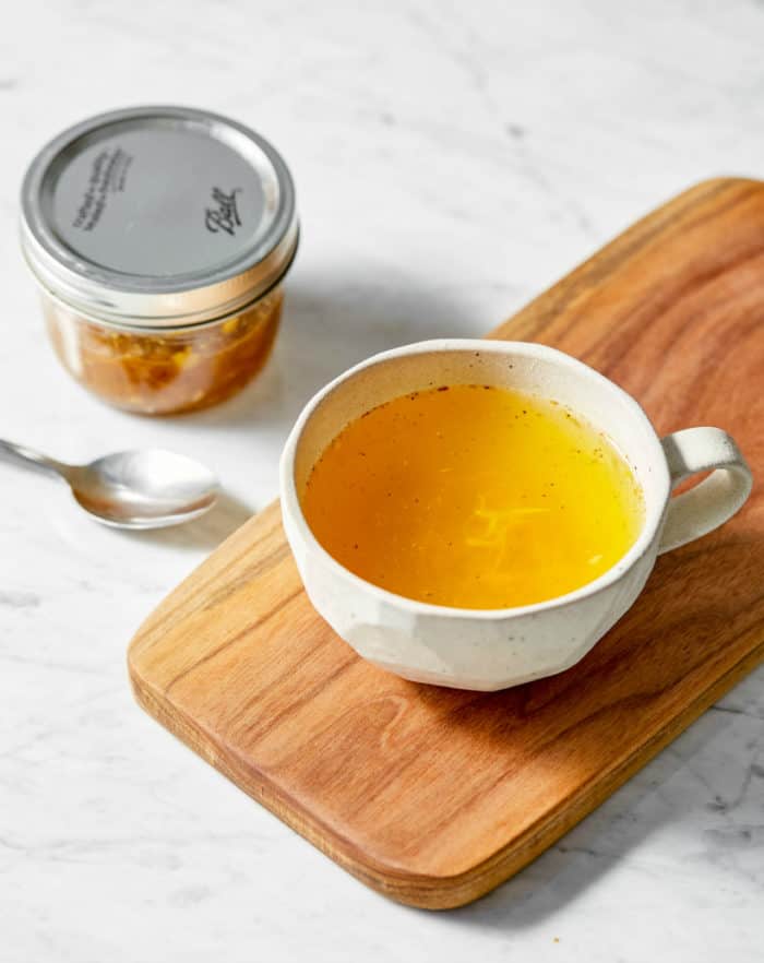 ginger turmeric tea in a mug on a wooden board