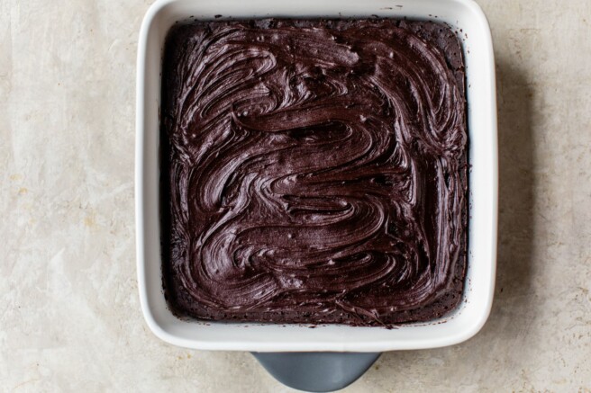 Pan of brownies topped with icing.