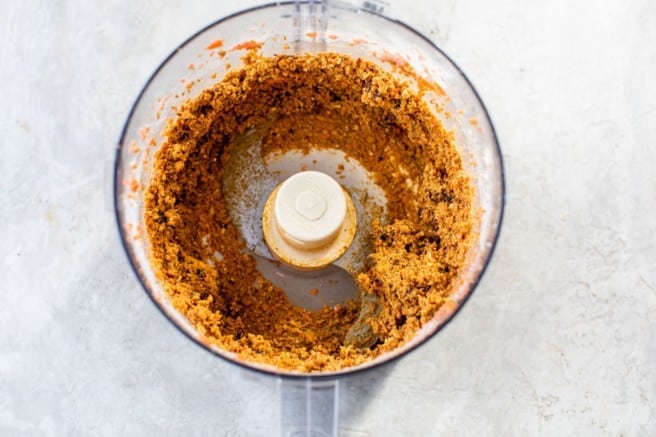 combining ingredients for carrot cake energy balls in a food processor