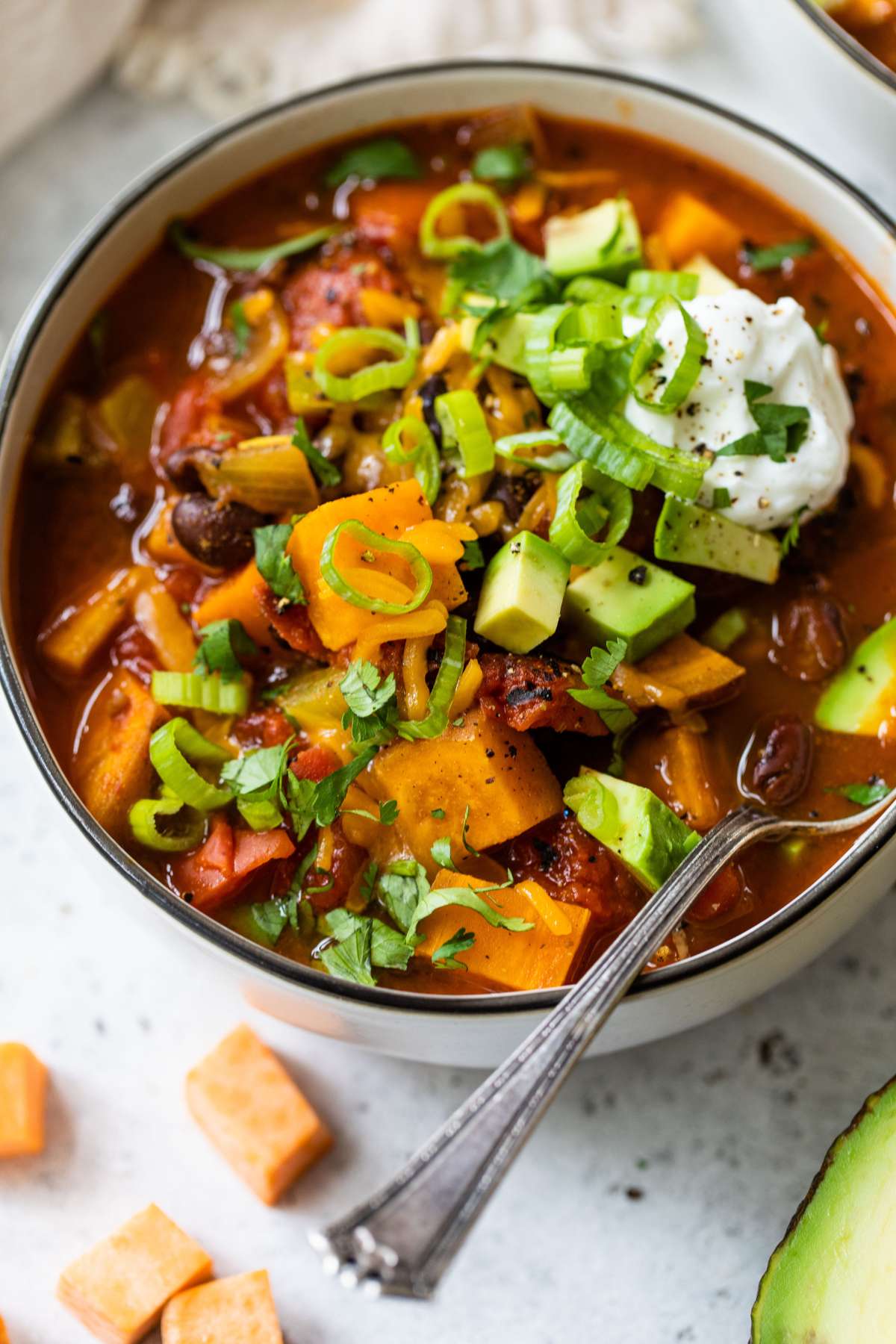 Black bean sweet potato chili in a bowl with a spoon.