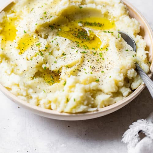 garlic mashed potatoes in a serving bowl with spoon