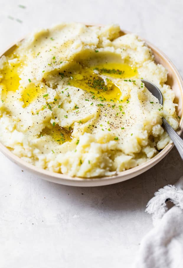 garlic mashed potatoes in a serving bowl with spoon