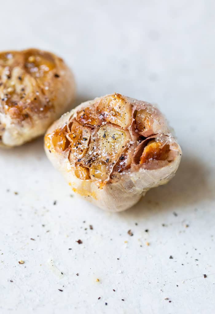 two pieces of roasted garlic on a counter