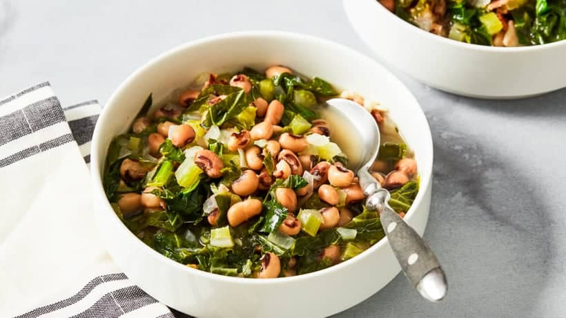 black eyed peas and collard greens in white bowl
