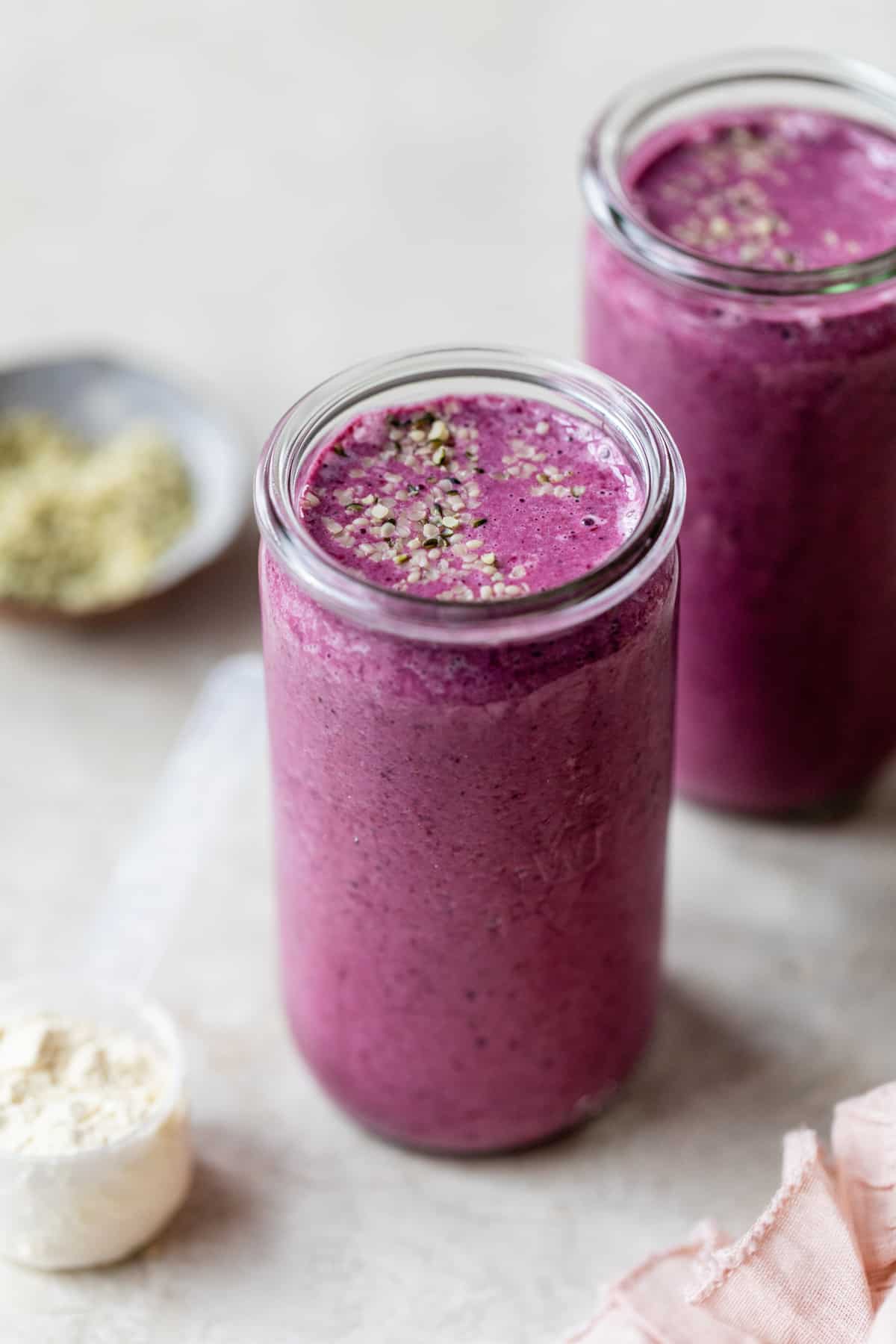 mixed berry and hemp seed smoothie in glass jar 