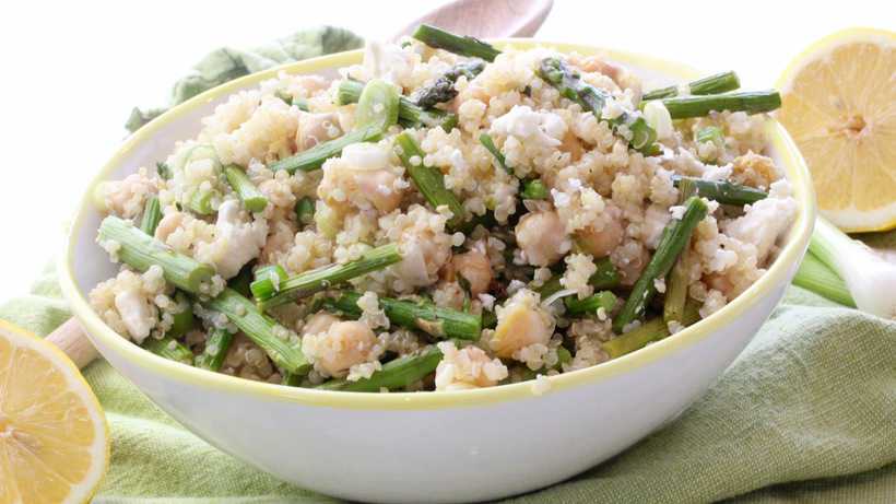 filling asparagus and quinoa salad in a bowl
