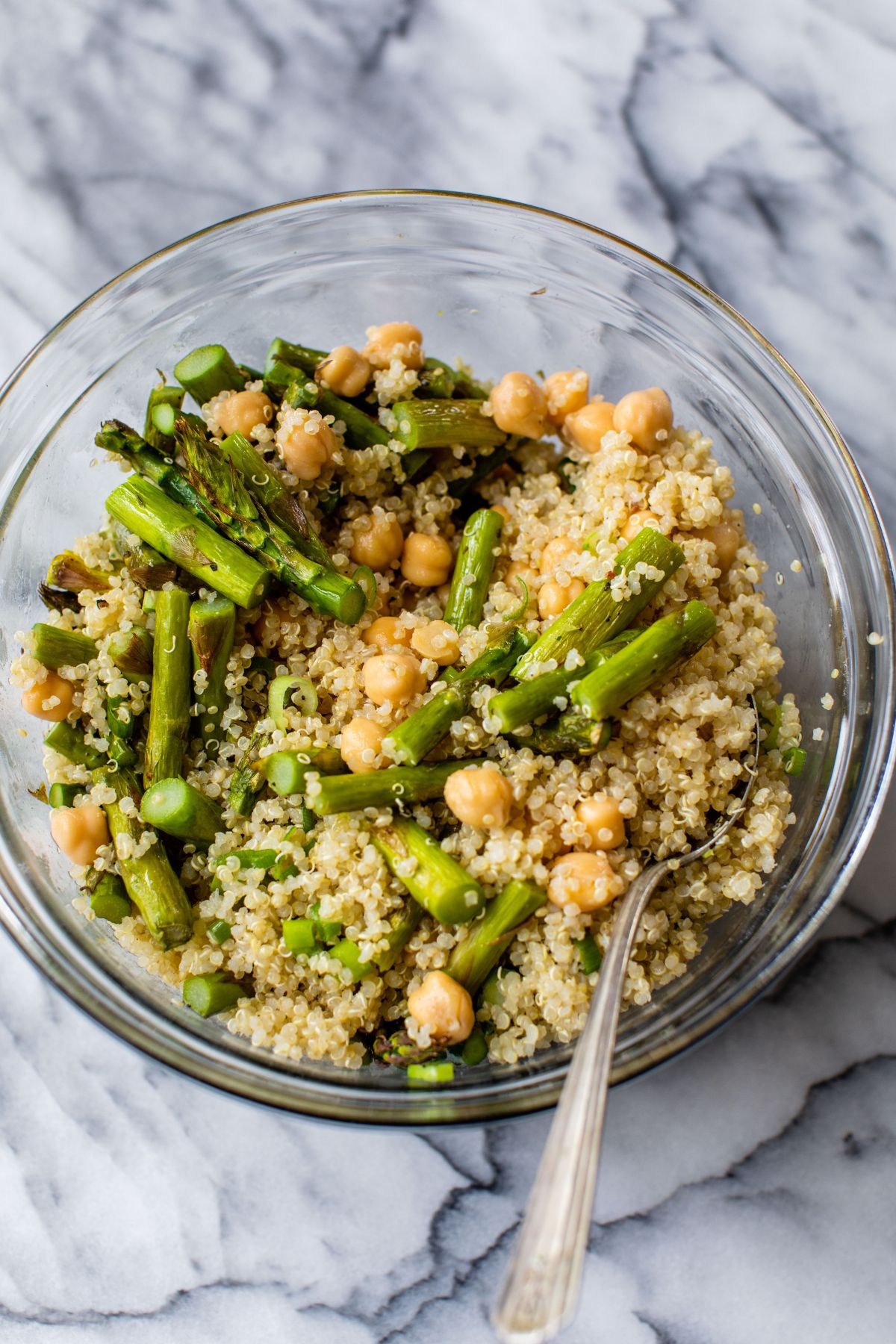 Mixing quinoa with roasted asparagus and chickpeas.