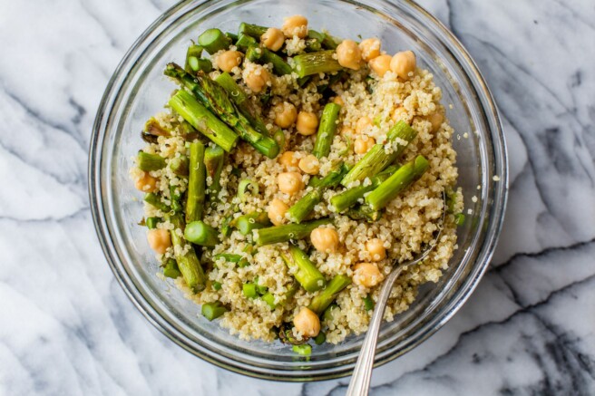 Mixing quinoa with roasted asparagus and chickpeas.