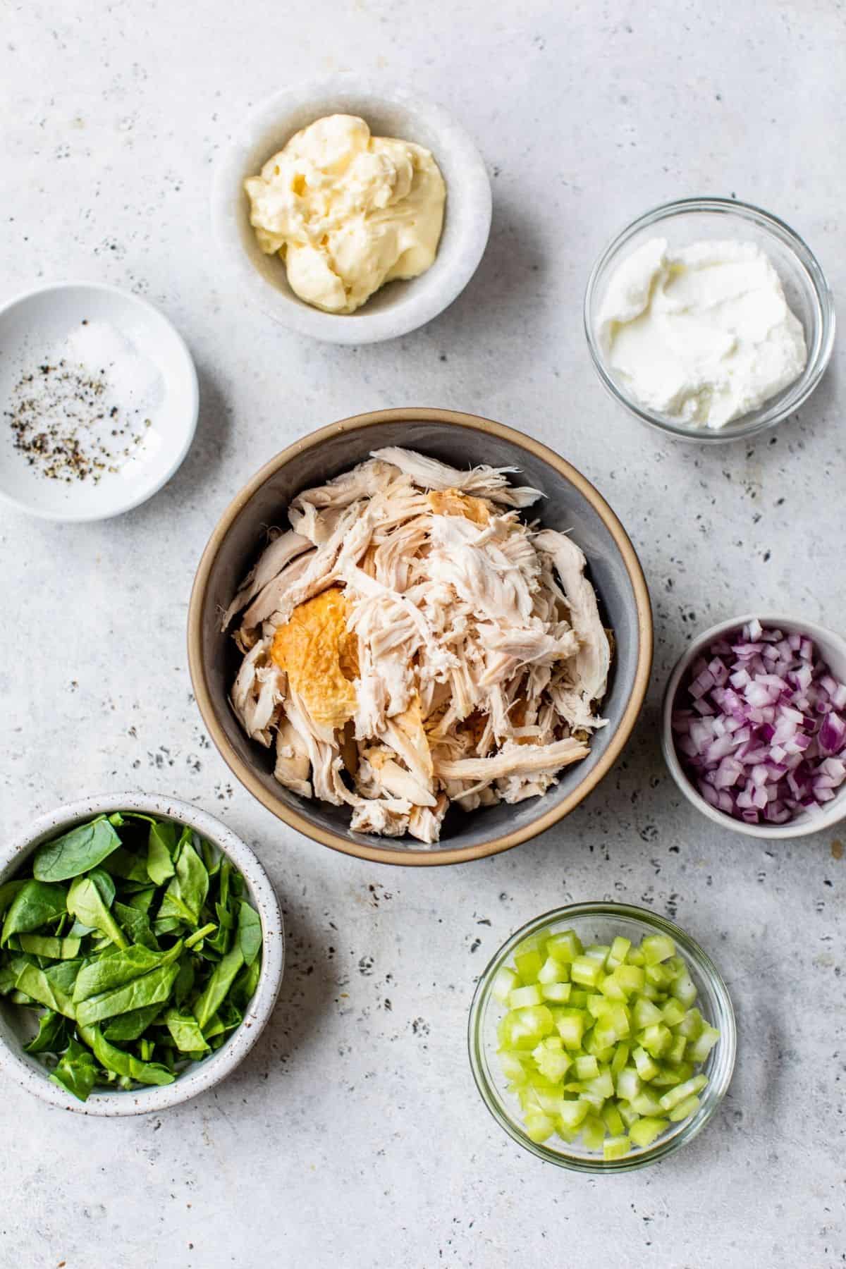 ingredients for chicken salad deviled into small bowls