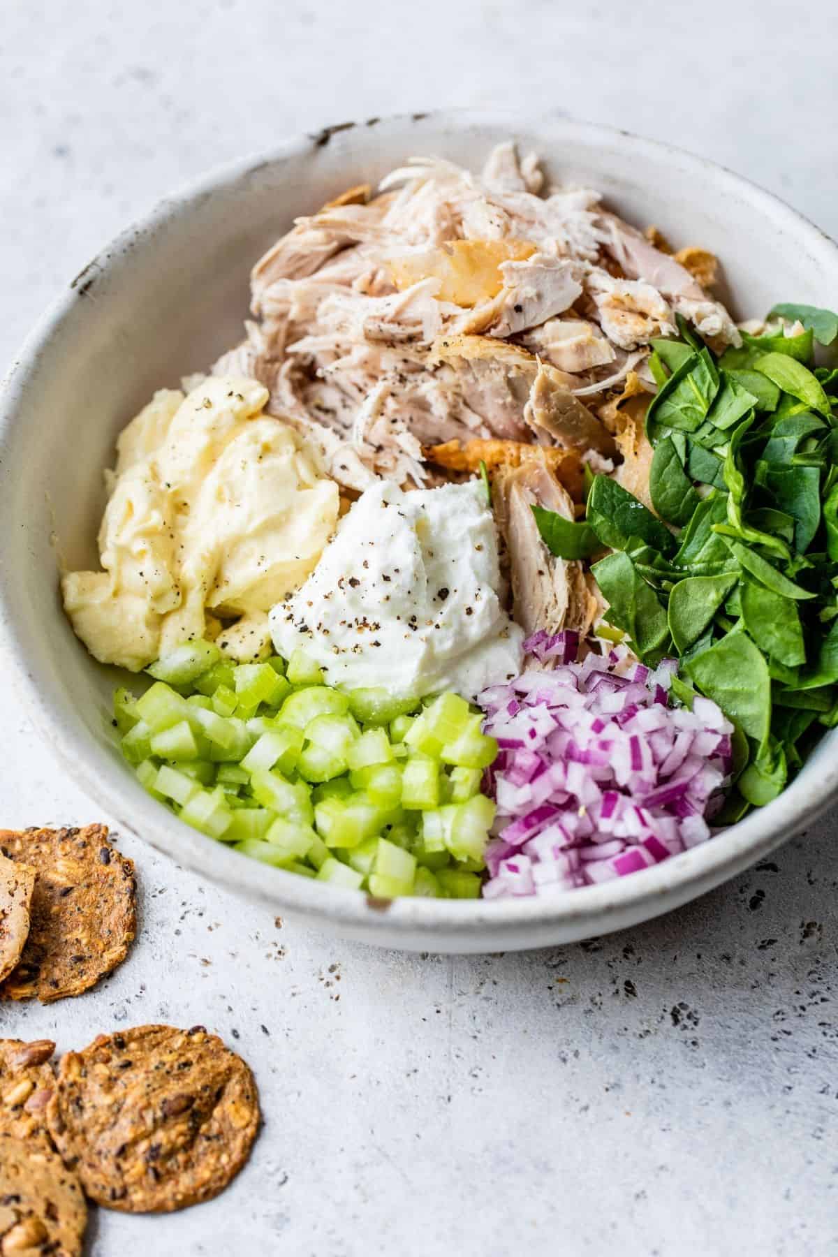 stirring together ingredients for rotisserie chicken salad