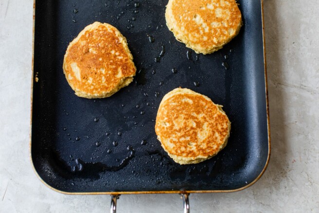 Cooking pancakes on a griddle.