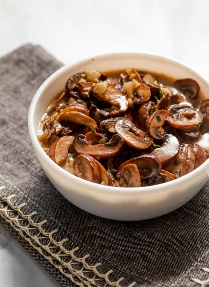 cooked creamy mushrooms in a small bowl