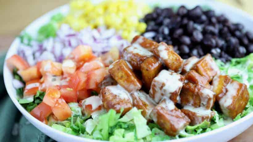 romaine lettuce topped with corn, black beans, tomatoes, red onion and bbq tofu