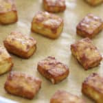 crispy baked tofu cubes on a rimmed baking sheet