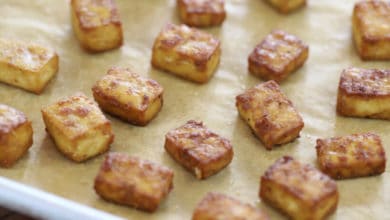 crispy baked tofu cubes on a rimmed baking sheet