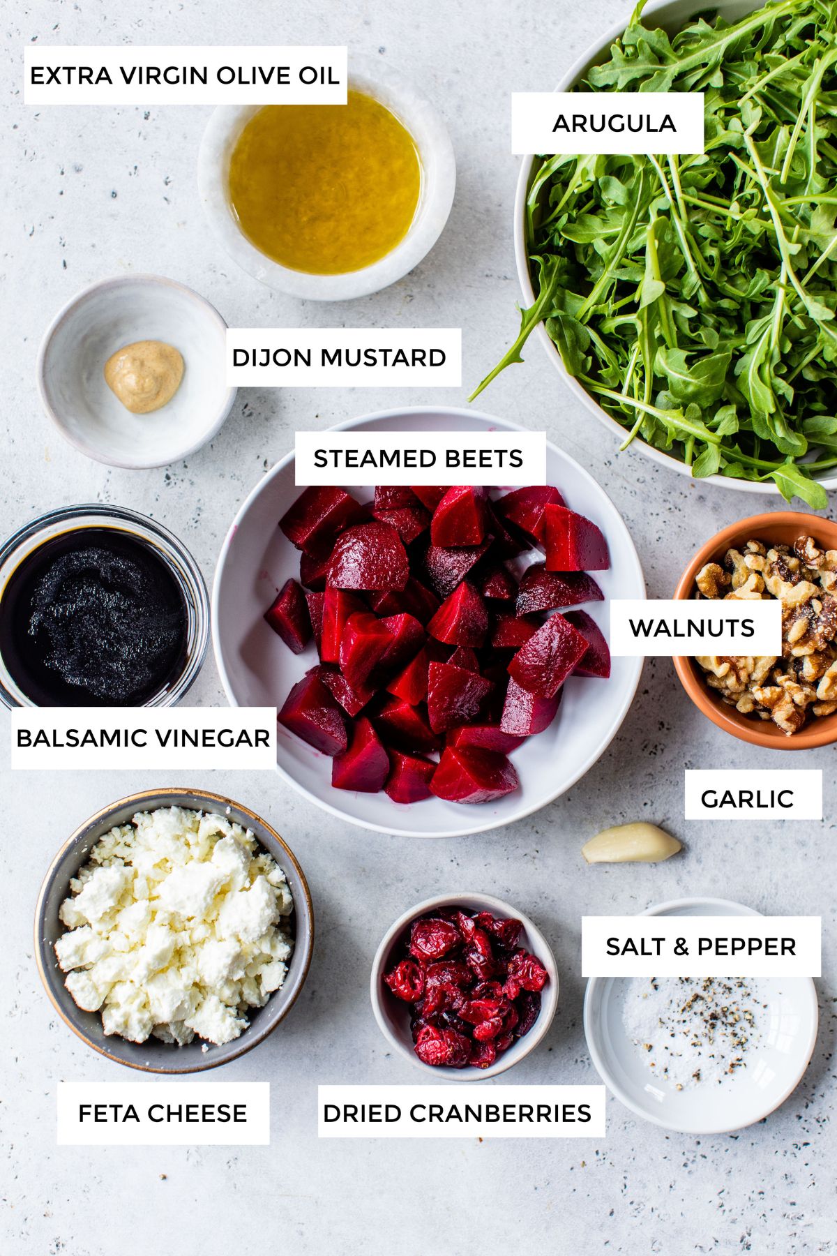 Ingredients for making beet salad portioned out into small servings.