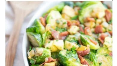 a white dish with a Brussels sprouts and bacon side dish